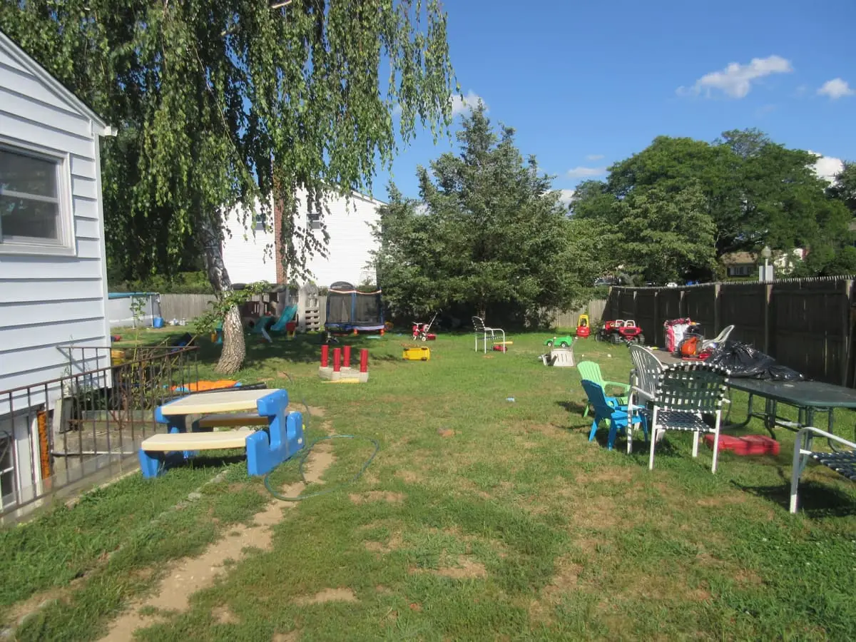Selling a rental property in Commack: backyard scattered with toys and play equipment