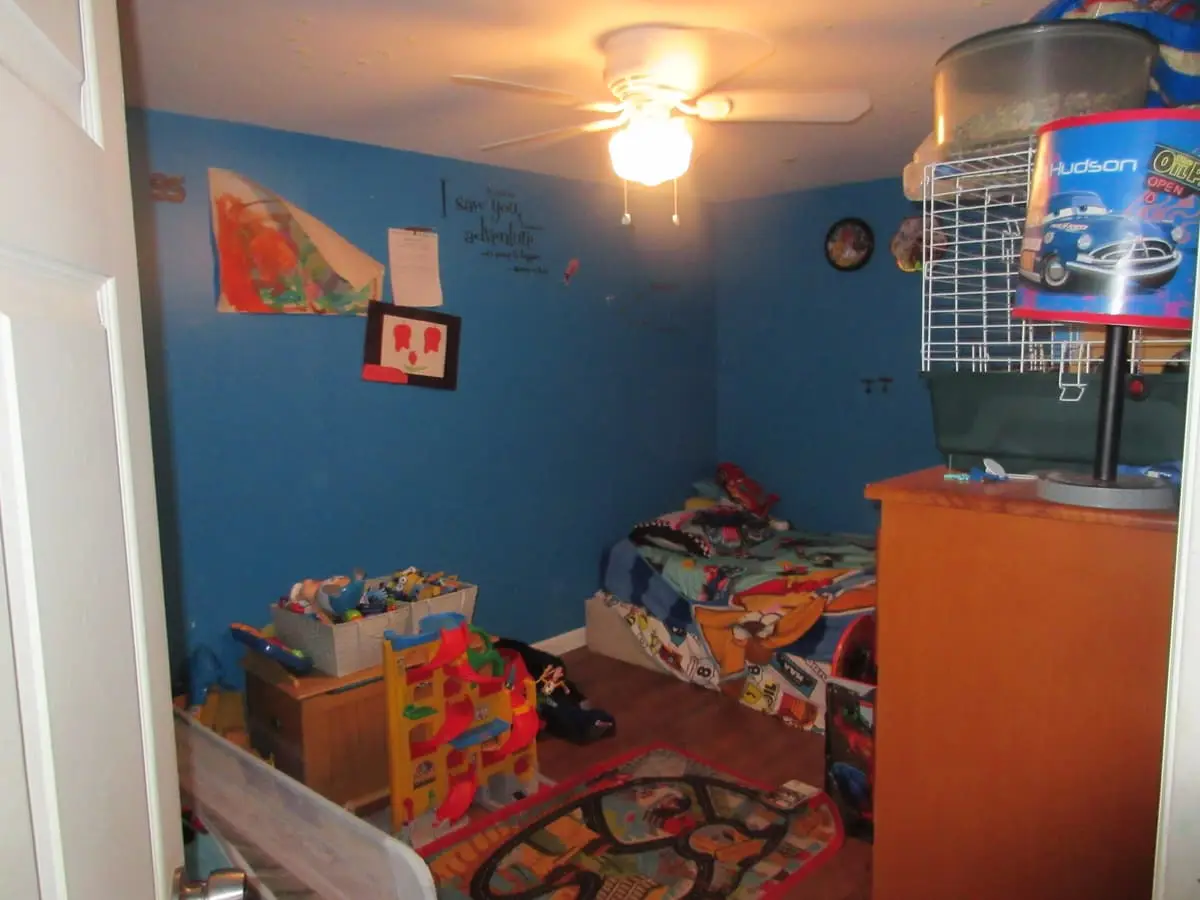 Selling without a realtor in Commack: blue bedroom with toys across the floor