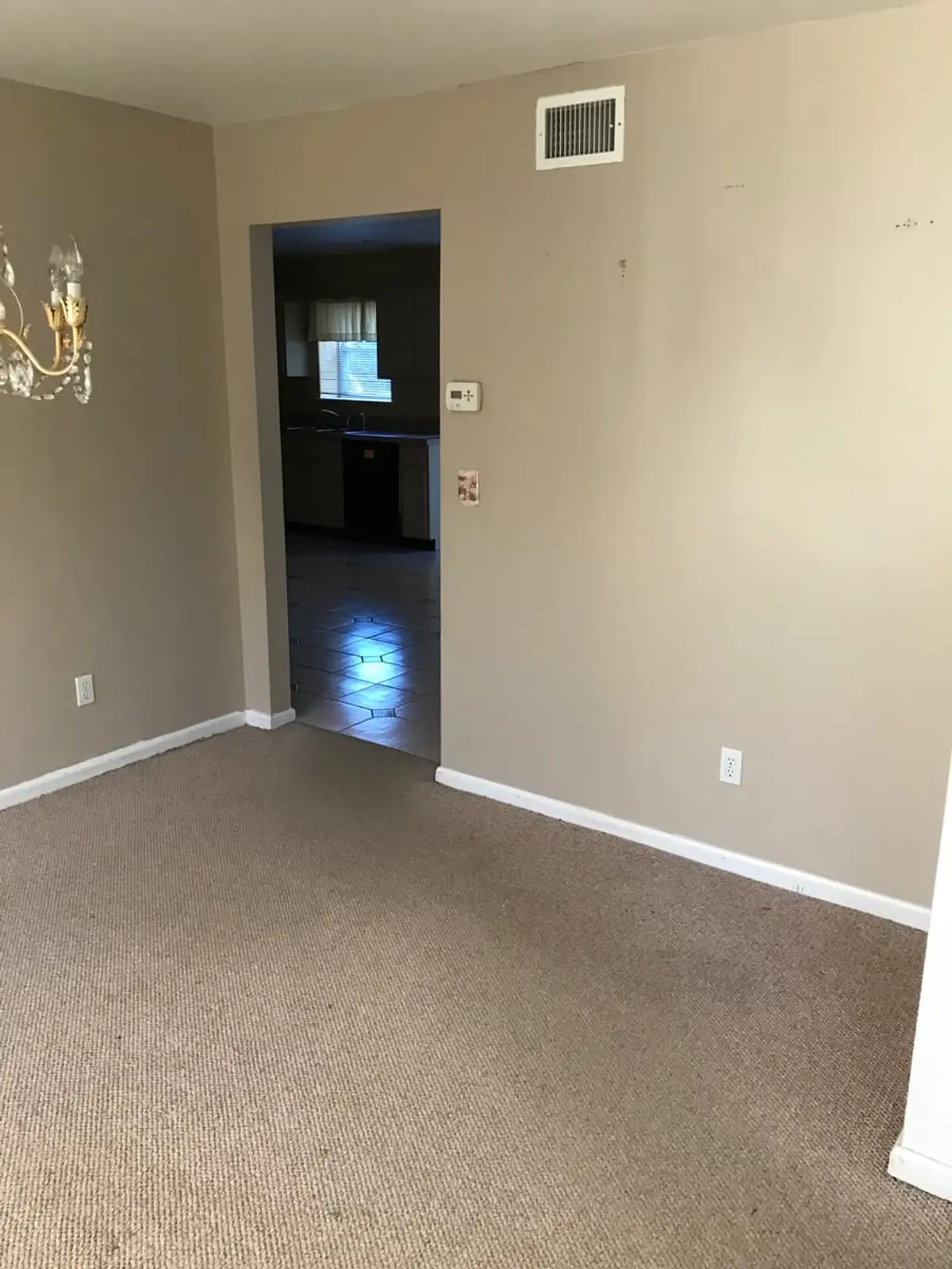 Trying to stop a foreclosure in Commack: empty carpeted room with tan walls