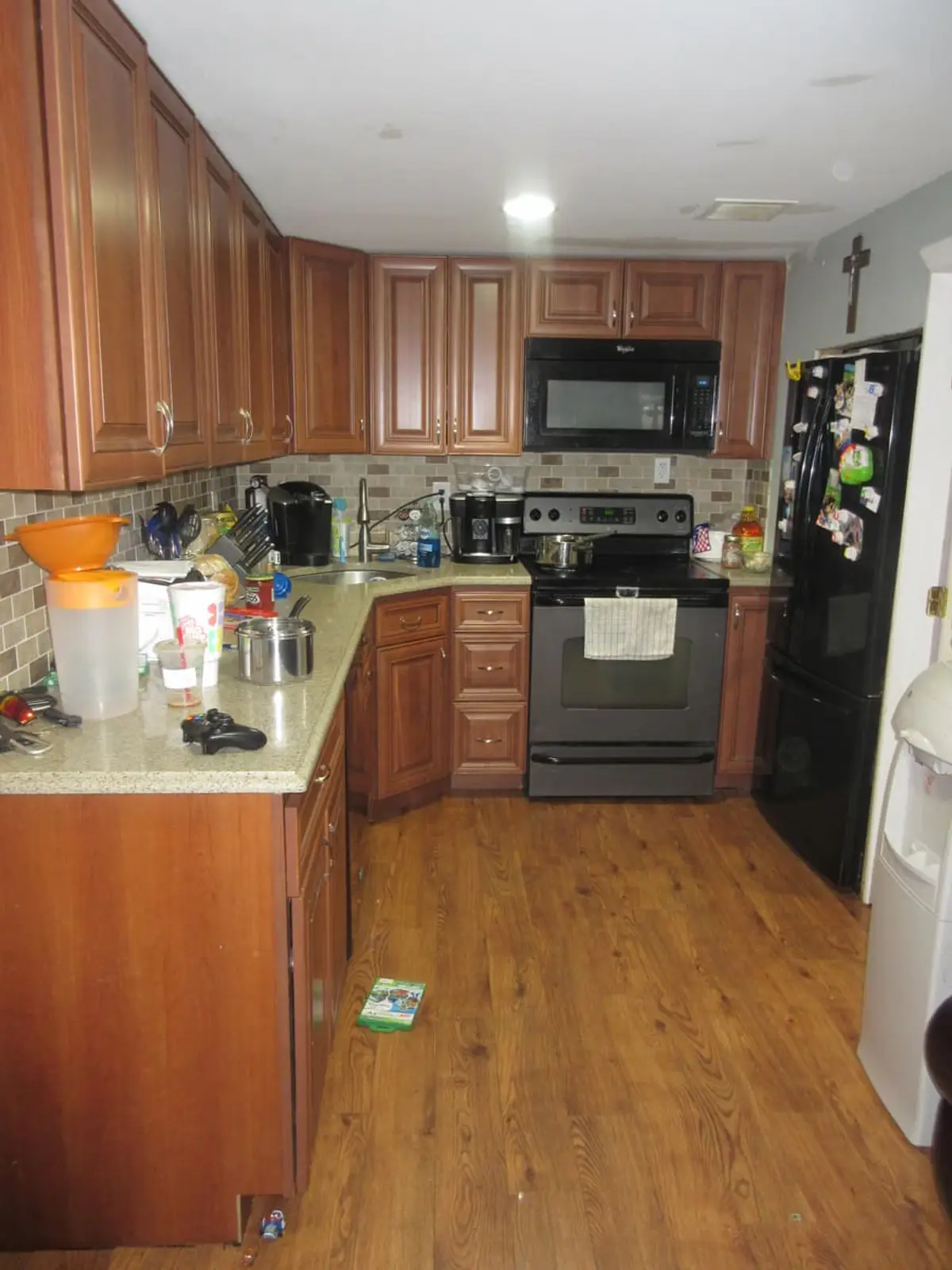 Wondering what your Commack house is worth: kitchen with cherry cabinets and a wood floor